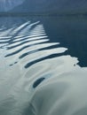 Rippling water in wake of slow boat across Lake Macdonald in Glacier National Park Royalty Free Stock Photo