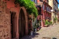 RIQUEWIHR, FRANCE - JULY 17, 2017: Picturesque street with traditional colorful houses in Riquewihr village on alsatian wine route Royalty Free Stock Photo