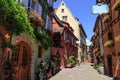 RIQUEWIHR, FRANCE - JULY 17, 2017: Picturesque street with traditional colorful houses in Riquewihr village on alsatian wine route Royalty Free Stock Photo