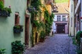 RIQUEWIHR, FRANCE - JULY 17, 2017: Picturesque street with traditional colorful houses in Riquewihr village on alsatian wine route Royalty Free Stock Photo