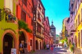 Riquewihr, France-June 23, 2016: Tourists are walking on the main shopping street in Riquewihr Royalty Free Stock Photo