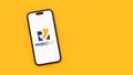 RISC-V, or Risc 5, Logo on Mobile Phone Screen on Yellow Background with Copy Space