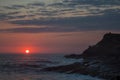 Riscos and sunset with red sun near Punta Comet Oaxaca Royalty Free Stock Photo