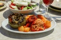 Rise stuffed fresh tomato and pepper in greek tavern. Royalty Free Stock Photo