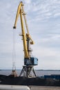 Rise tower crane over coastal terminal as charcoal is being loaded onto trains for transport Royalty Free Stock Photo