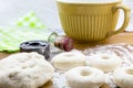 Risen doughnut dough on flowered wood table with cutter and rolli