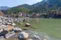 Rishikesh, holy town and travel destination in India, famous for yoga classes. Clear sky and transparent Ganges River.