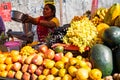 Indian woman prepares fresh fruit juice from her market booth to sell to customers Royalty Free Stock Photo