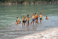 Indian boys swimming in the sacred water of the river Ganges in the city of Rishikesh, India