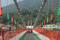 Bridge over Ganga river, Ram Jhula, Rishikesh. People crossing Ram Jhula bridge. Royalty Free Stock Photo