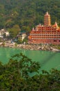 View of Ganga river embankment, Lakshman Jhula bridge and Tera Manzil Temple, Trimbakeshwar in Rishikesh Royalty Free Stock Photo