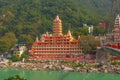 View of Ganga river embankment, Lakshman Jhula bridge and Tera Manzil Temple, Trimbakeshwar in Rishikesh Royalty Free Stock Photo