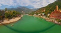 View of Ganga river embankment, Lakshman Jhula bridge and Tera Manzil Temple, Trimbakeshwar in Rishikesh Royalty Free Stock Photo