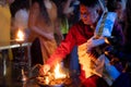 hindu priest sitting on the bank of ganga river lit from one side by the fire from an oil lamp a key component in Royalty Free Stock Photo