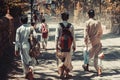 Rishikesh, 2017, Indian children, boys, walk with backpacks along the village street, sacred cows lie on the roadside 1 Royalty Free Stock Photo