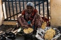 Rishikesh, 2017, an old Indian woman cooks and sells fresh tortillas on the street at a fair in India 1