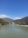 Rishikesh seen from the ganges river with mountains in background Royalty Free Stock Photo