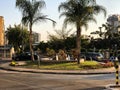 RISHON LE ZION, ISRAEL -APRIL 23, 2018: Roundabout with small fountain on the street with palms in Rishon Le Zion, Israel.