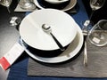 RISHON LE ZION, ISRAEL- DECEMBER 16, 2017: Table setting of an empty white plate with silverware spoon.