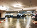 RISHON LE ZION, ISRAEL- JANUARY 3, 2018: Parking garage underground interior, neon lights in dark industrial building. Royalty Free Stock Photo