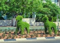 Two decorative figures of topiary goats following each other