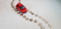 Red fiat 500 abarth toy making its way on road line made of one Israeli shekel coins