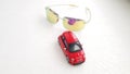 Small red Fiat 500 toy rear view reflected in sunglasses Royalty Free Stock Photo