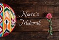 Rishtan Uzbek national plate and pink spring flower with congratulatory text. Postcard for Navruz
