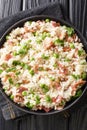 Risi e Bisi classic Italian comfort food of rice with peas and chunks of ham close up in a plate. Vertical top view Royalty Free Stock Photo