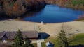 Rising Aerial shot reveals beautiful changing colors along Lake Mohegan