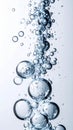Rising Bubbles Against Pale Blue Background in Vertical Shot Close Up View Royalty Free Stock Photo