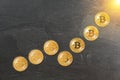 Rising chart made of gold bitcoin coins, concept of cryptocurrency value growing to the moon / sun