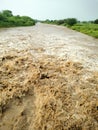 Rising flood water swirls after heavy rains in Indian.