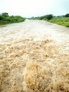 Rising flood water swirls after heavy rains in Indian.