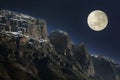 Rising full moon over the rocky summits Royalty Free Stock Photo