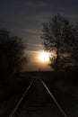 Rising full moon over a single railway-line