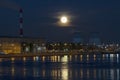 rising moon over two cooling towers on the river bank Royalty Free Stock Photo