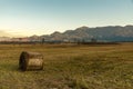 The rising moon with a hay bale in the foreground