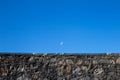 Rising Moon Over Ancient Stone Parapet Wall