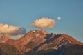 Rising moon and setting Sun over Piz Mitgel massif