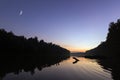 Rising new moon at sunset, over river. Crescent moon Clear sky. Royalty Free Stock Photo