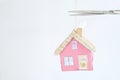 Rising rents, heating costs and prices for homes, model home hanging by a thread, metaphoric or symbloic picture Royalty Free Stock Photo