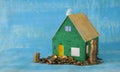Rising rents,  heating costs and prices for homes, model home with stacked money, conceptual,symbolic picture.Free copy space Royalty Free Stock Photo