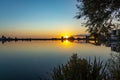 The rising sun has completely dissolved the morning mist above lake Noordhovense plas and the smooth water reflects the horizon be Royalty Free Stock Photo