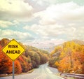 RISK AHEAD sign against road - Business concept Royalty Free Stock Photo