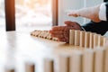 Risk concept with hand of businessman stopping and protection the domino effect Royalty Free Stock Photo