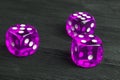 Risk concept - playing dice at black wooden background. Playing a game with dice. Pink casino dice rolls. Rolling the dice concept Royalty Free Stock Photo