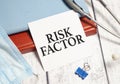 RISK FACTOR word on notebook, stethoscope and protective mask Royalty Free Stock Photo