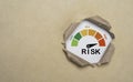 Risk level indicator rating inside punch brown paper from low to high on for business risk management analysis and assessment Royalty Free Stock Photo