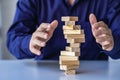 risk management concepts Hands trying to protect the crumbling wooden blocks block tower businessman